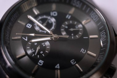 Black color wristwatch for men. Morden stylish black hand watch, closeup, dark hours