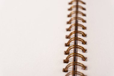 Blank spiral bound notebook. Close-up of blank paper notebook in a binder with metal ring binding, macro, real photo