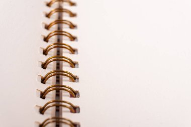 Blank spiral bound notebook. Close-up of blank paper notebook in a binder with metal ring binding, macro, real photo