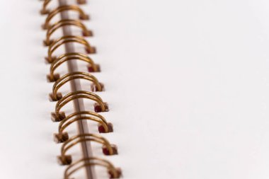 Blank spiral bound notebook. Close-up of blank paper notebook in a binder with metal ring binding, macro, real photo