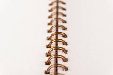 Blank spiral bound notebook. Close-up of blank paper notebook in a binder with metal ring binding, macro, real photo