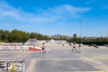 Istanbul, Turkey - 17 September, 2022: Skate park in outdoors. Skateboard area with bowls, ramps in the city public park, sunny summer day. Freestyle extreme sports. Outdoor activity for children