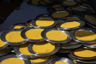 Traditional Turkish and Arabic dessert knafeh, kunefe. Delicious uncooked kunafa on copper tray plates. Middle eastern sweet sheese pastry. Kadaif, knafeh pastry cooked on the stove. Uncooked, raw