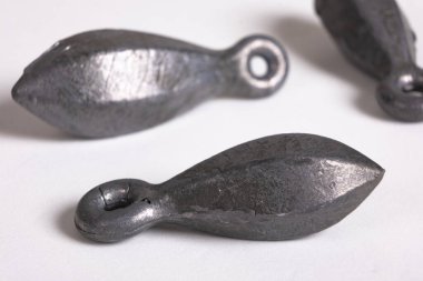 Lead fishing weights cast sinkers isolated on white background. Equipment or tools. Heap of lead sinker weights for fishing, bullet bank accessories