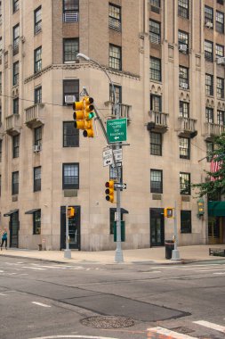 Trafik ışıkları ve tarihi binanın ön cephesinin olduğu bir şehir kavşağı. Broadway 'de güneye giden trafik işaretleri var. Mimari ve sokak yaşamını yansıtan bir şehir manzarası