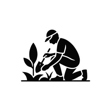 Gardener watering plants with a watering can, kneeling in a garden