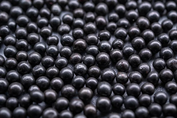 Koyu küresel çelik bir fotoğraf, aşındırıcı patlamalar ve yüzey hazırlıkları için kullanılan bir medya..