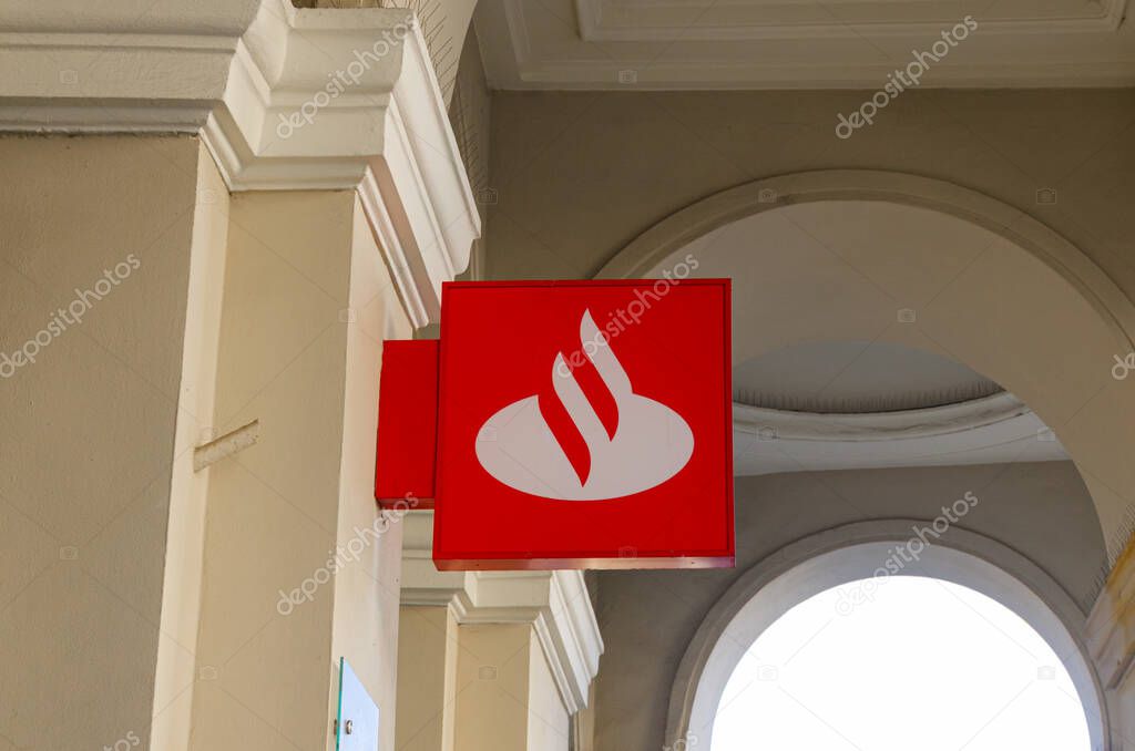 Warsaw, Poland - 20.10.2025: Santander Bank branch at Pl. Zbawiciela, historic building with classical columns, bank logo visible, urban architecture, city center.