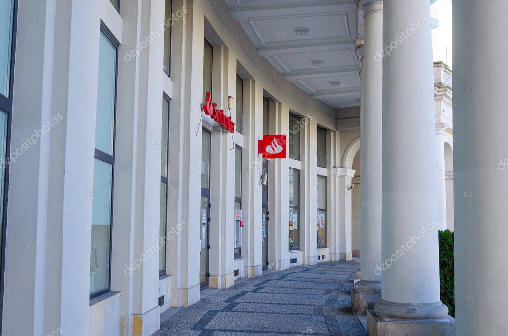 Warsaw, Poland - 20.10.2025: Santander Bank branch at Pl. Zbawiciela, historic building with classical columns, bank logo visible, urban architecture, city center.