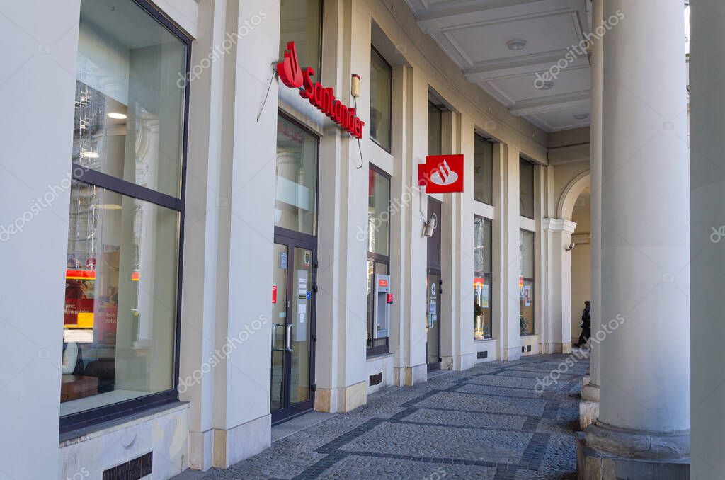 Warsaw, Poland - 20.10.2025: Santander Bank branch at Pl. Zbawiciela, historic building with classical columns, bank logo visible, urban architecture, city center.