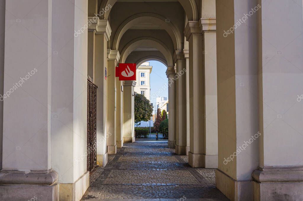 Warsaw, Poland - 20.10.2025: Santander Bank branch at Pl. Zbawiciela, historic building with classical columns, bank logo visible, urban architecture, city center.