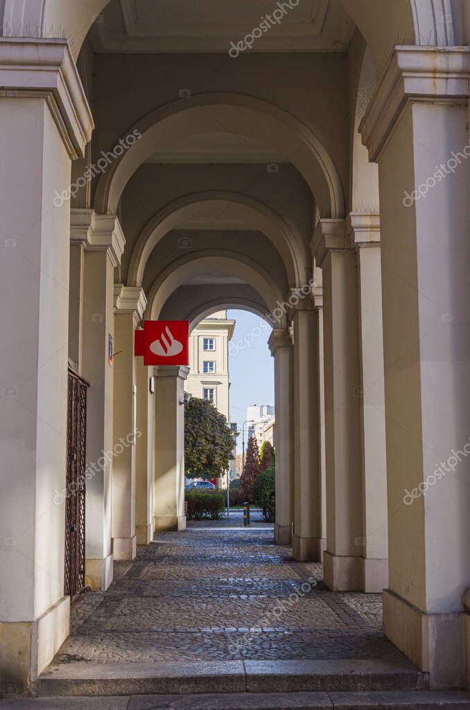 Warsaw, Poland - 20.10.2025: Santander Bank branch at Pl. Zbawiciela, historic building with classical columns, bank logo visible, urban architecture, city center.