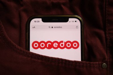 KONSKIE, POLAND - 04 Eylül 2021: Kooredoo QSC logosu kot pantolon cebine gizlenmiş cep telefonunda sergilendi