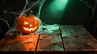 halloween pumpkin with a spider web on a black table