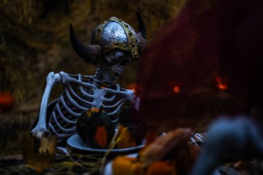 Cadılar Bayramı. Karanlık arka planda kafatası ve kemikleri olan ürkütücü cadılar bayramı iskeleti Cadılar Bayramı gecesi için ürkütücü bir şekilde ışıldayan korku dekorasyonu..