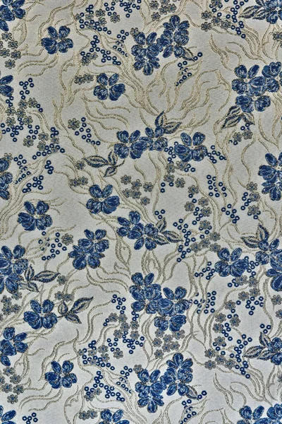 Tekstil kumaş dokusu soyut bir desen ile koyu mavi çiçekler ve lurex (parıltı) ipliğinden yapılmış altın yapraklar. Bu bir grunge tarzı çiçek motifi, döşeme, perde ve 3D tasarım için mükemmel..