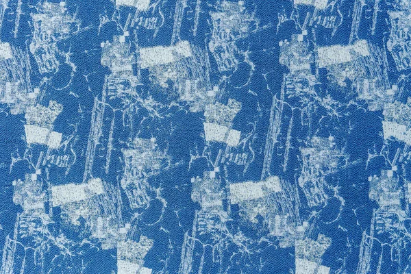 Bir kumaş dokusunun, grunge etkisi olan yakın çekimi, zengin mavi tonların bir kombinasyonu ile karakterize edilir, bir desen ve lurex ile.