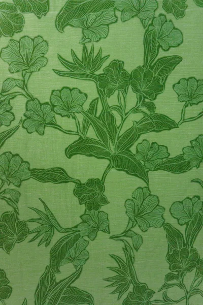 Kalın ve enerjik limon yeşili tekstil dokusunun biraz daha koyu renkli çiçek desenli yakın çekimi. Göz alıcı tasarımlar, ambalajlar ve doğa temalı projeler için mükemmel.