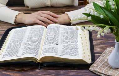 Kahveli ve çiçekli Tahta Masa 'da Dua ve İncil Çalışması