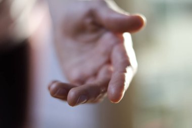 Yumuşak doğal ışıkta yumuşak jestler ve ince hareketler gösteren insan ellerinin yakın plan görüntüleri