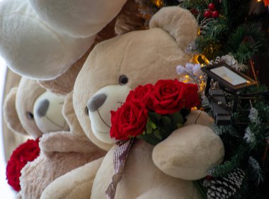 Noel 'de dekore edilmiş bir mağazanın önünde kırmızı güllerle büyük oyuncak ayılar..