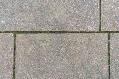 Detailed texture of concrete paving slabs with fine aggregate for urban backgrounds.