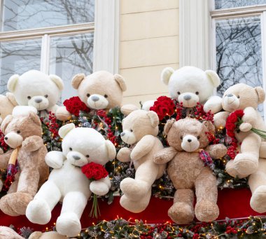 Oyuncak ayılar ve çiçeklerle şehirdeki bir Noel dükkanının vitrininde şenlik düzenlemesi..