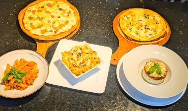 Assorted Italian Dishes with Pizza, Pasta, and Baked Meals