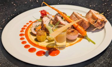 Gourmet Stuffed Chicken Roulade with Vegetables and Sauce