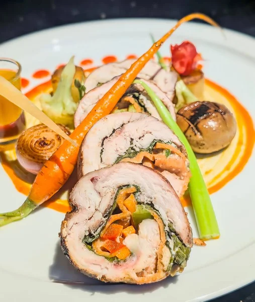 Gourmet Stuffed Chicken Roulade with Vegetables and Sauce