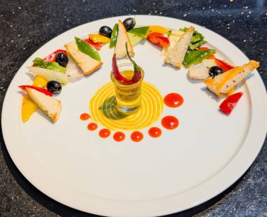 Elegant fine dining presentation of a gourmet salad with grilled bread, bell peppers, olives, and artistic sauce decoration on a white plate. Modern culinary plating ideal for restaurant.