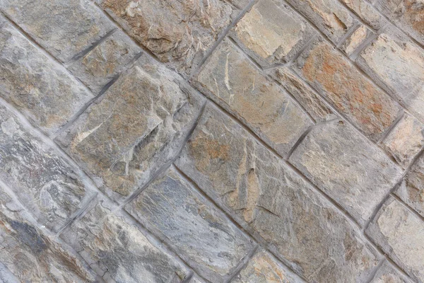 Taş karolarla çevrili bir duvar parçası. Tasarım için arkaplan.