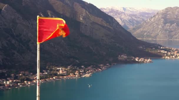 Bandiera nazionale Montenegro contro la baia e la montagna di Boka Kotor — Video Stock