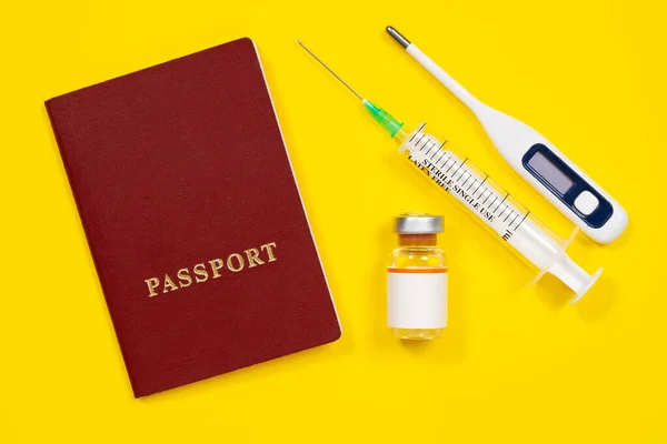 New travel rules during the coronavirus pandemic. Basic necessities for first aid during trip, yellow background, top view, copy space. Health checks and tests for infectious diseases before vacation