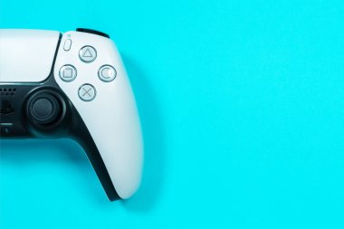 Budva, Montenegro - March 16, 2021: New product from Sony, wireless white Play Station 5 gamepad on blue background