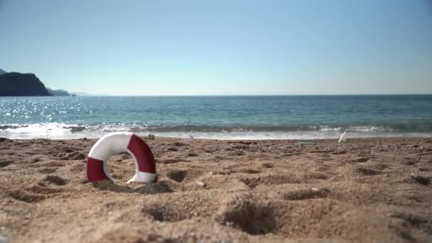 Sauveur de vie sur une plage de sable vide contre les vagues de la mer — Video