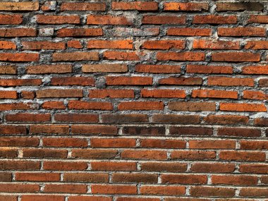 Yıpranmış turuncu ve kırmızı tuğla işi yüzeyi, endüstriyel iç tasarım kavramları için mükemmel.