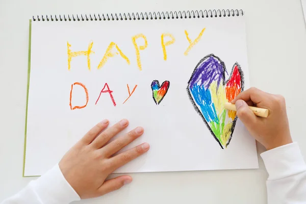 Child hands drawing vibrant letters with crayons, preschool art project, fun creative activity at home or school