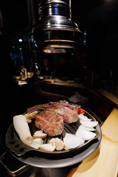 Korean BBQ Beef on Table Grill with Mushrooms and Vegetables