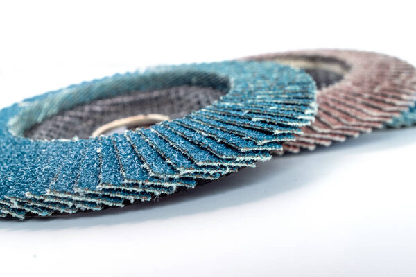 Abrasive flap discs for metal grinding and surface finishing, arranged on a white background. Ideal for industrial design, tool catalogs,