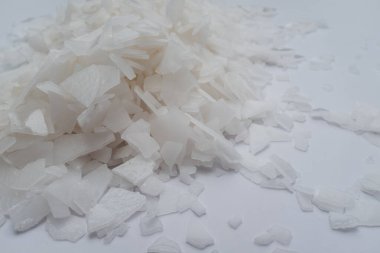 Beyaz arka planda magnezyum tuz tanelerinin yakın çekimi, detaylı beyaz parçacıklar deniz tuzu, doğal desen. Magnezyum terapisi, Sağlık Sigortası, kişisel bakım, sağlığın iyileştirilmesi, ev istirahatı.