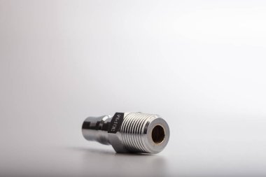 Açık gri arkaplana karşı pnömatik sistemler için paslanmaz çelik konnektörü