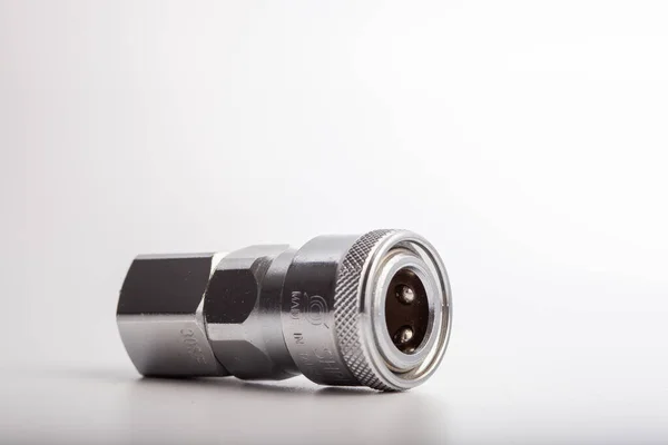 Açık gri arkaplana karşı pnömatik sistemler için paslanmaz çelik konnektörü