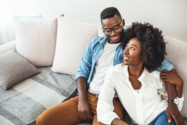 Couple relaxing on sofa. Young couple relaxing having nap or breathing fresh air, relaxed man and woman enjoying rest on comfortable sofa in living room. 