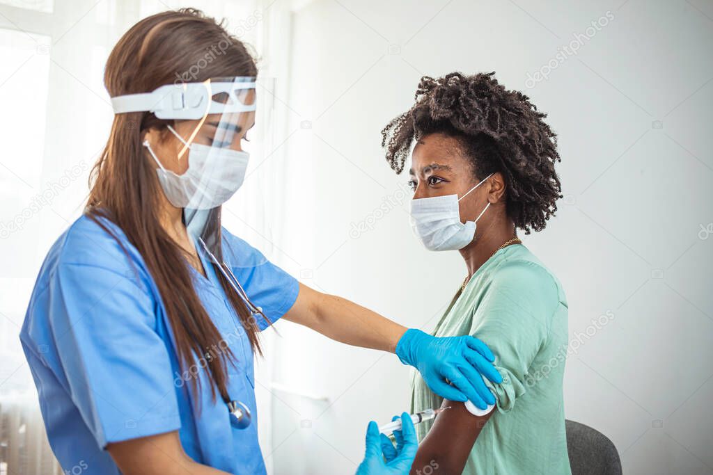 Woman with face mask getting vaccinated, coronavirus, covid-19 and vaccination concept. Prevention is better than cure. Doctor giving a woman a vaccination. Virus protection. COVID-2019.