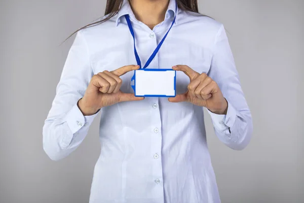 Woman holding Identification white blank plastic id card. Close-up of a blank business card in businesswoman\'s hand. You can put your text. Blank business card