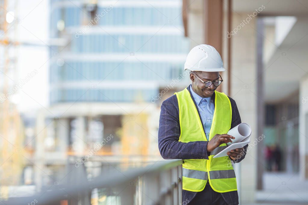 Construction Worker Planning Constractor Developer Concept. Portrait of an engineer holding a blueprint at a construction site. Overseeing the building process