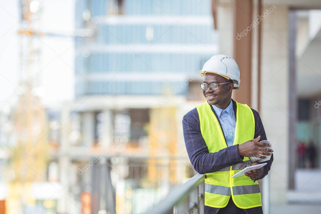 Construction Worker Planning Contractor Developer Concept. Portrait of African American Engineer at a construction work site. Successful male architect at a building site 