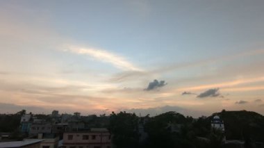 Şiddetli, karanlık bulutlarla dolu dramatik bir gökyüzü ağaçların karanlık siluetleri üzerinde belirir, karamsar ve atmosferik bir sahne yaratarak yaklaşan bir fırtınayı ya da hava değişimini gösterir..