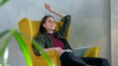 Kadın kafa masajcısıyla rahatlıyor. Modern iç mekanda.